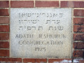 A close-up view of the cornerstone on the front, left side of the building.