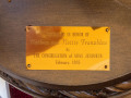 The plaque on the Torah stand on the left side of the bema.
