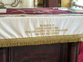 A close-up view of the front of the cloth covering the top of the pulpit.