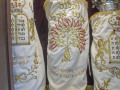 A close-up view of the three Torah scrolls in the open ark.