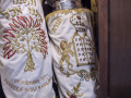 A close-up view of the middle and right Torah scrolls on the right side of the ark