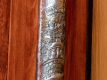 A close-up view of the mezuzah below the plaque on the inside of the left, front door of the lobby.