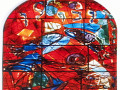 A close-up view of the middle stained glass panel on the top row of the stained glass artwork on the left wall of the sanctuary.