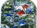 A close-up view of the left stained-glass panel in the middle row of the stained glass artwork on the left wall of the sanctuary.