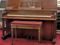 A close-up view of the piano on the far, left side of the right wall of the sanctuary.