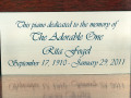 A close-up view of the plaque on the piano.