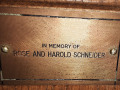 A close-up view of the plaque on the sixth pew from the front on the left side of the sanctuary.