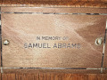 A close-up view of the plaque on the seventh pew from the front on the left side of the sanctuary.