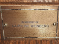 A close-up view of the plaque on the eighth pew from the front on the left side of the sanctuary.