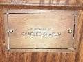 A close-up view of the plaque on the eighth pew from the front, on the right side of the sanctuary.