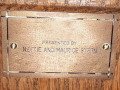 A close-up view of the plaque on the nineth, and last, pew from the front, on the right side of the sanctuary.