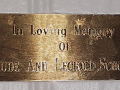 A close-up view of the plaque to the right of the window by the 4th pew from the front of the sanctuary.