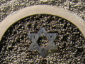 A close-up view of the metal Star of David over the front door of the synagogue.