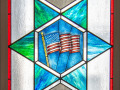 A close-up view of the middle panel of this stained-glass window.