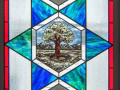 A close-up view of the second stained-glass window on the left side of the sanctuary.