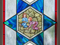 A close-up view of the second stained-glass window on the right side of the sanctuary.