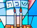 A close-up view of the top panel of the stained-glass window on the front wall of the sanctuary, to the left of the ark.