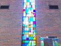 A view of the third, full length stained-glass window from the left, on the left wall of the sanctuary.