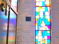 A view of the fourth, full-length stained-glass window from the right, on the right wall of the sanctuary.
