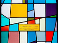 A close-up view of the inscription on this stained-glass window.