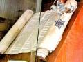 A view of the Zbraslav Holocaust Torah, the Eternal Flame, and the framed Nazi Inventory Tag.