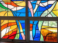 A close-up view of the memorial panes on the third and fourth panels (from the left) of the stained-glass windows in the social hall.