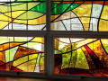 A close-up view of the memorial panes on the 5th and 6th (from the left) panels on the stained-glass windows in the social hall.