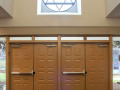 A view of the front doors to the synagogue, looking from the back wall of the lobby toward the front doors.