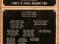 A close-up view of the top plaque on the wall above the table next to the Judaica store.