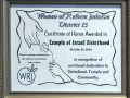 A close-up view of the far, right plaque on the wall to the right of the bulletin board in the alcove.
