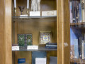 A view of items in the glass-front cabinet in the library.