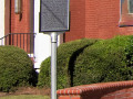 A close-up view of the Jewish Historical Society marker in front of the synagogue.