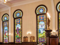 A close-up view of the stained glass windows on the left side of the sanctuary.