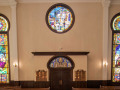 A close-up view of the stained glass windows on the back wall of the sanctuary.
