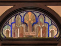 A close-up view of the stained glass panel directly above the doors at the back of the sanctuary.