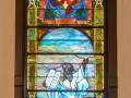 A close-up view of the second stained glass window on the left wall of the sanctuary.