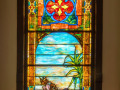 The first stained glass window, closest to the bema, on the right wall of the sanctuary.