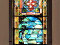 The third stained glass window on the right wall of the sanctuary.