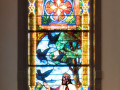 The fifth stained glass window on the right side of the sanctuary. This window is on the back, right wall of the sanctuary, to the right of the front doors.