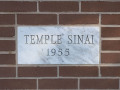 A close-up view of the cornerstone, to the left of the front doors of the synagogue.