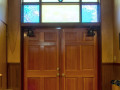 A close-up view of the front doors of the synagogue, looking from the doorway of the sanctuary toward the front of the building.