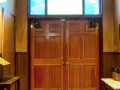 A view of the lobby, looking from the doors of the sanctuary toward the outside doors of the synagogue.