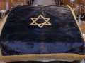 A close-up view of an older pulpit cloth that is no longer used.