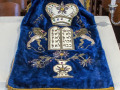 A close-up view of a Torah cover that is no longer used.
